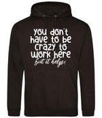 You Don't Have to Be Crazy to Work Here but It Helps! hoodie in jet black